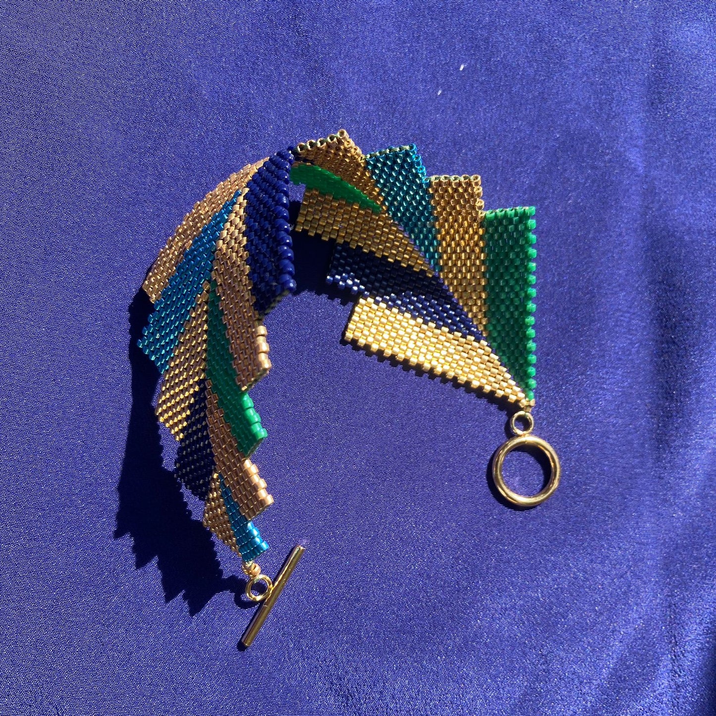 Brazalete Capella Pavo Real - Asimétrico