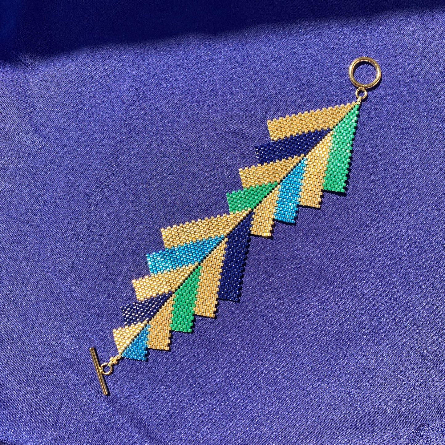 Brazalete Capella Pavo Real - Asimétrico